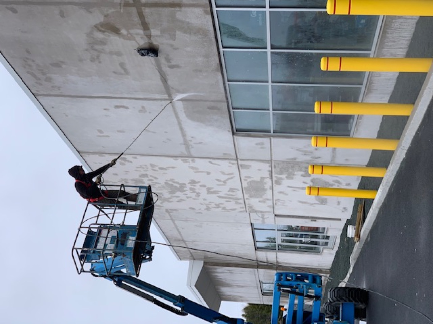 O'Brien's Faster Blaster washing a commercial building exterior from a lift in Nova Scotia