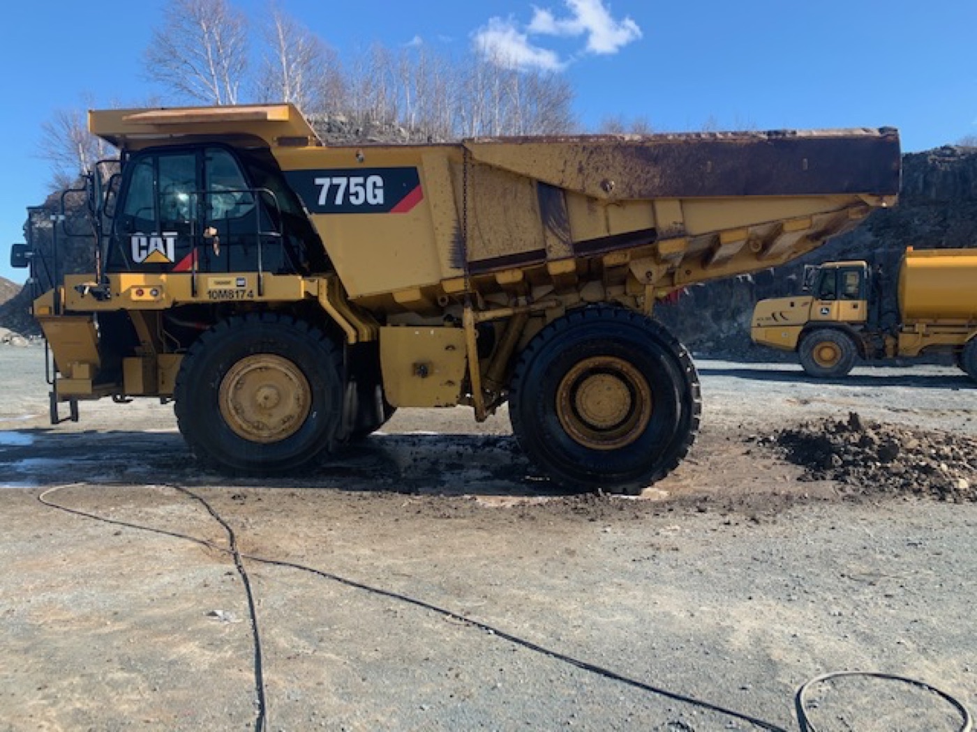A CAT 775 haul truck washed clean, paint and markings visible again
